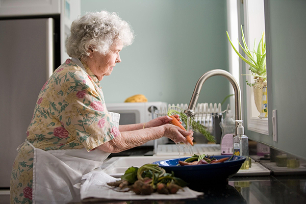 Elderly Lady Preparing Food